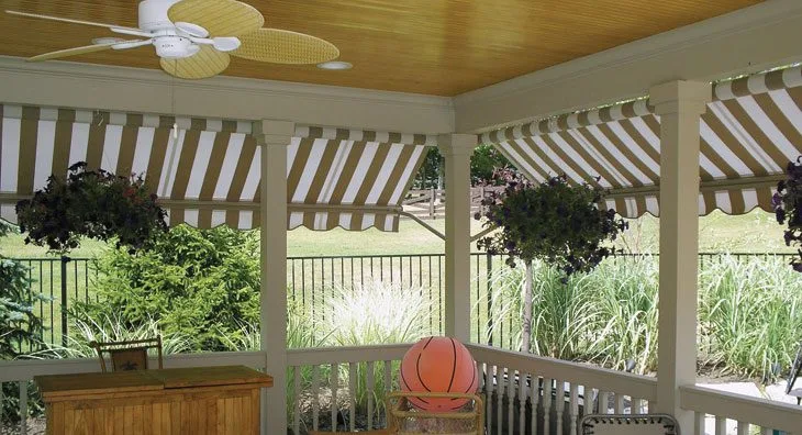 Eclipse™ drop arm awning providing vertical shade and privacy on a residential patio